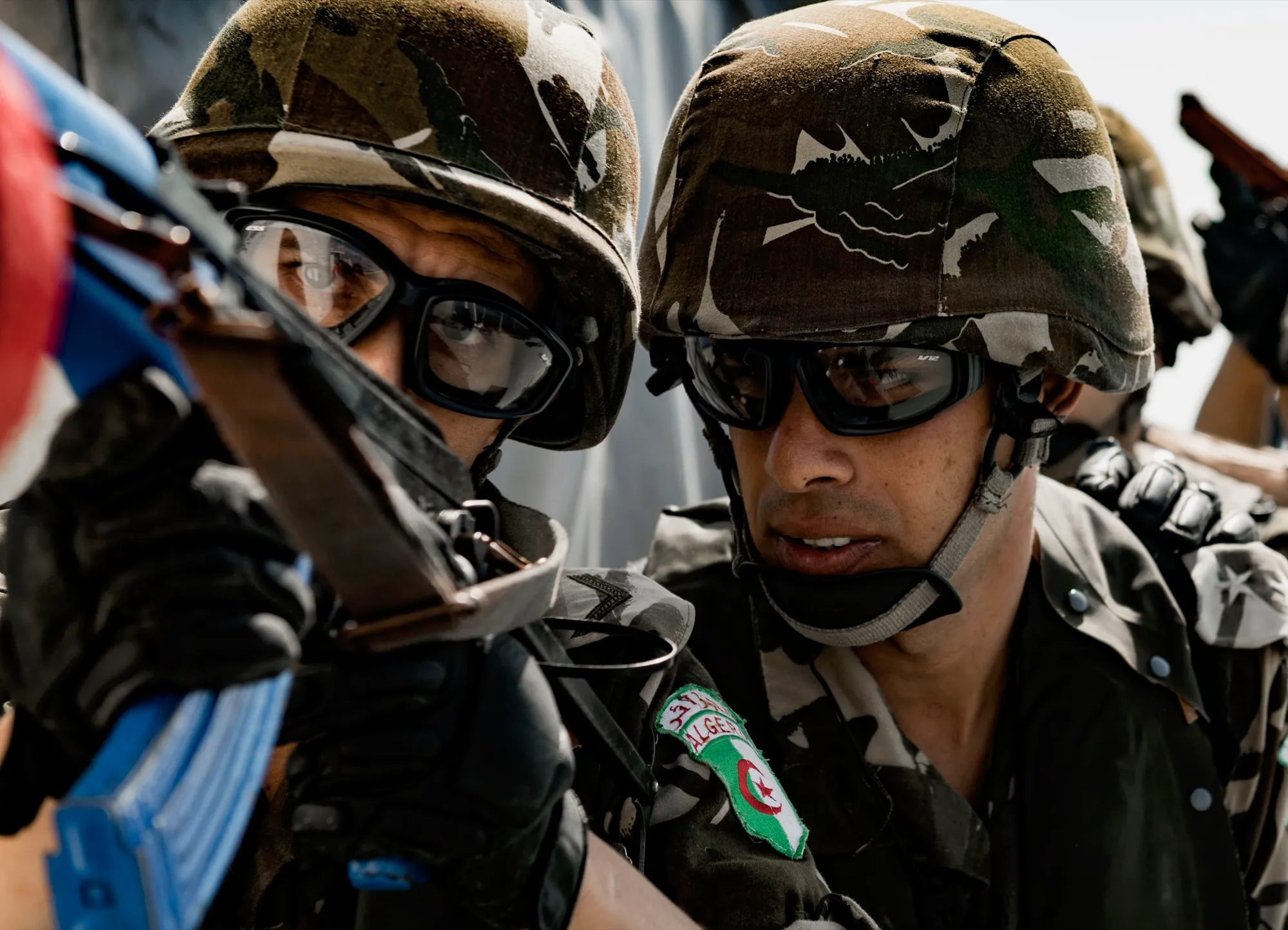 Soldiers confer during a joint training exercise — documentary photograph by Ryan Utah